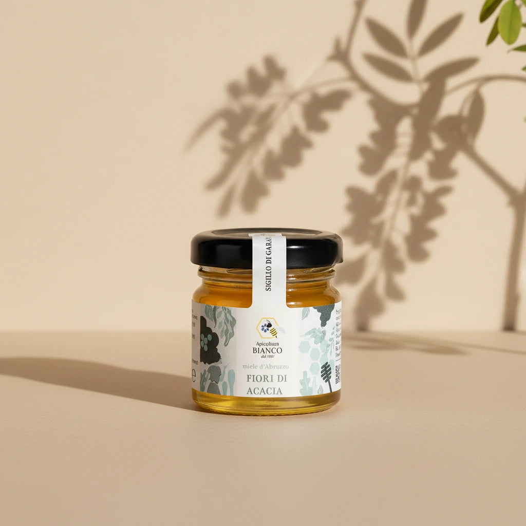 Small jar of honey with a label on artistic background
